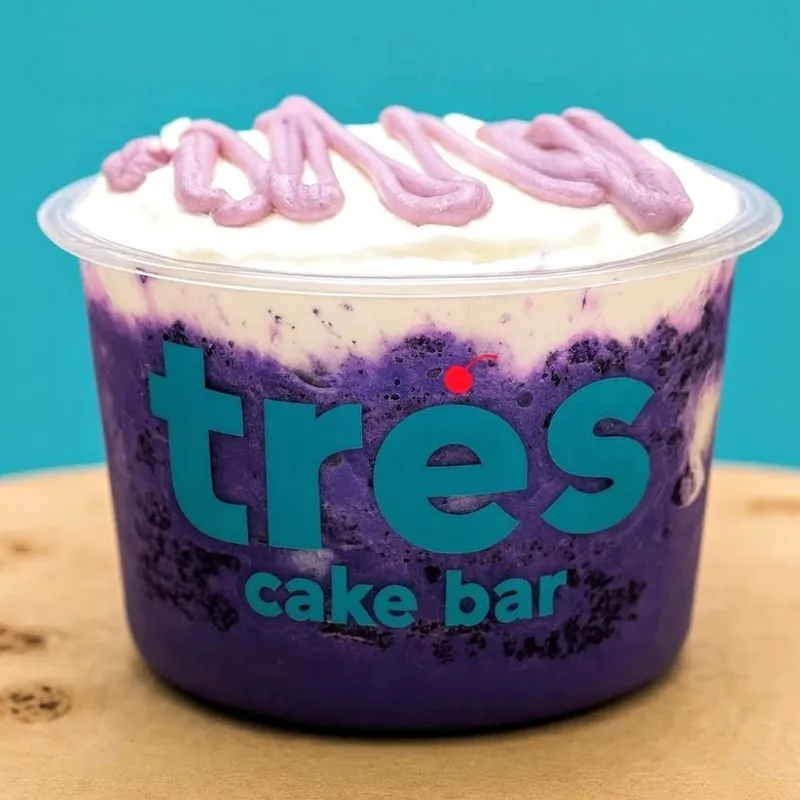 Purple ube tres leches cup with a whipped topping
